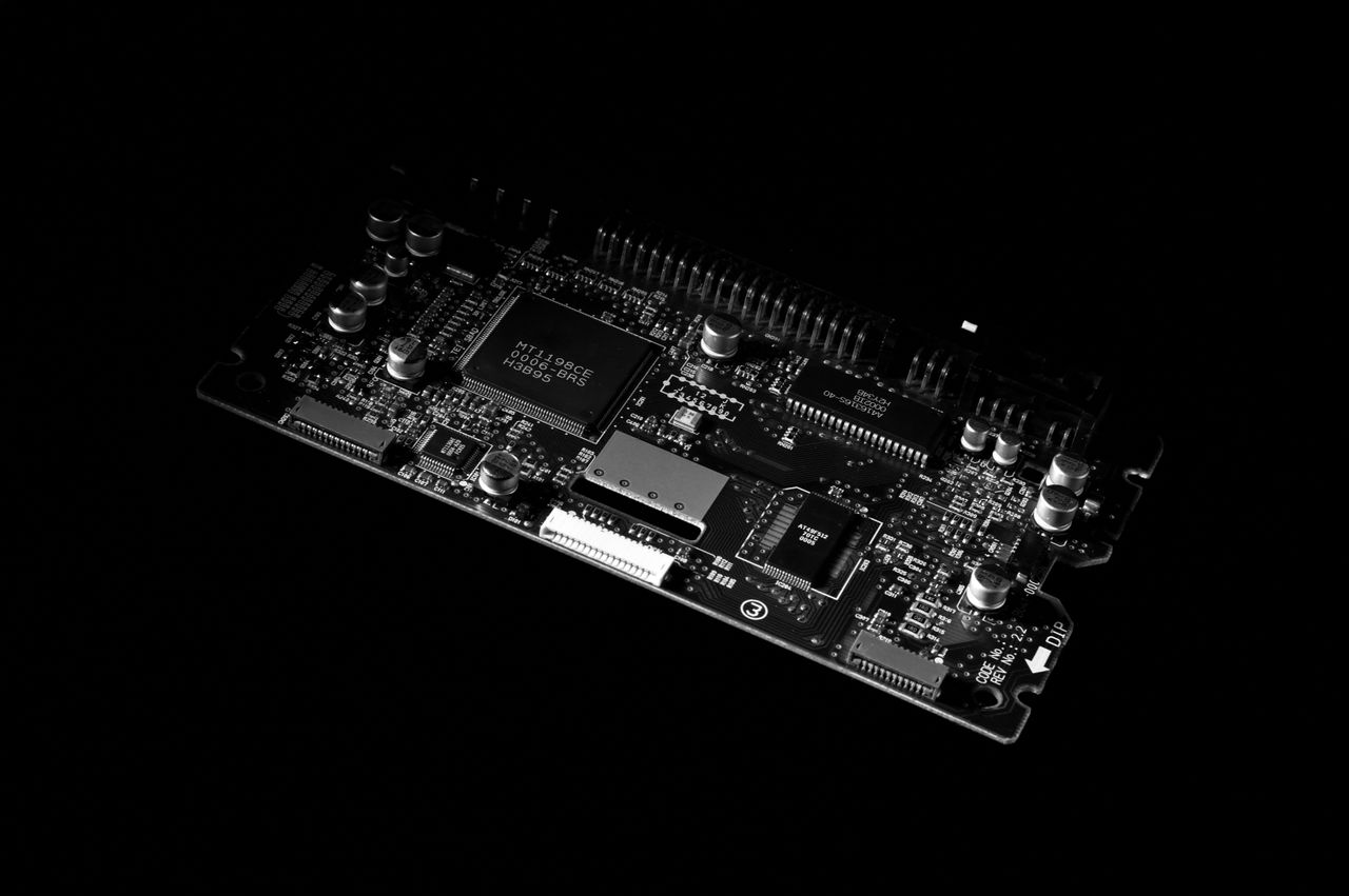 heros-img Detailed black and white image of a computer circuit board, showcasing technology components.
